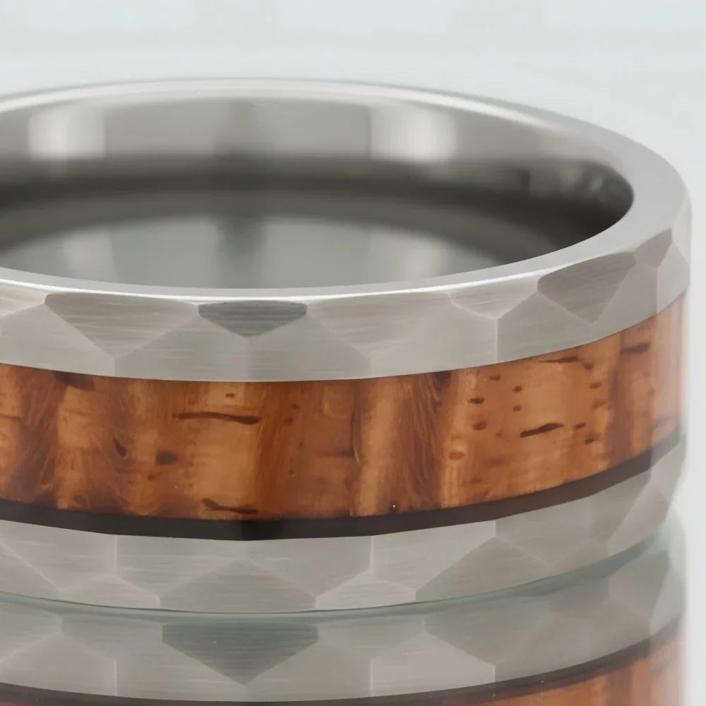 Macro detail of faceted edges and natural wood grain on The Heritage Cask showcasing whiskey barrel wood inlay and Aerospace-grade Tungsten.