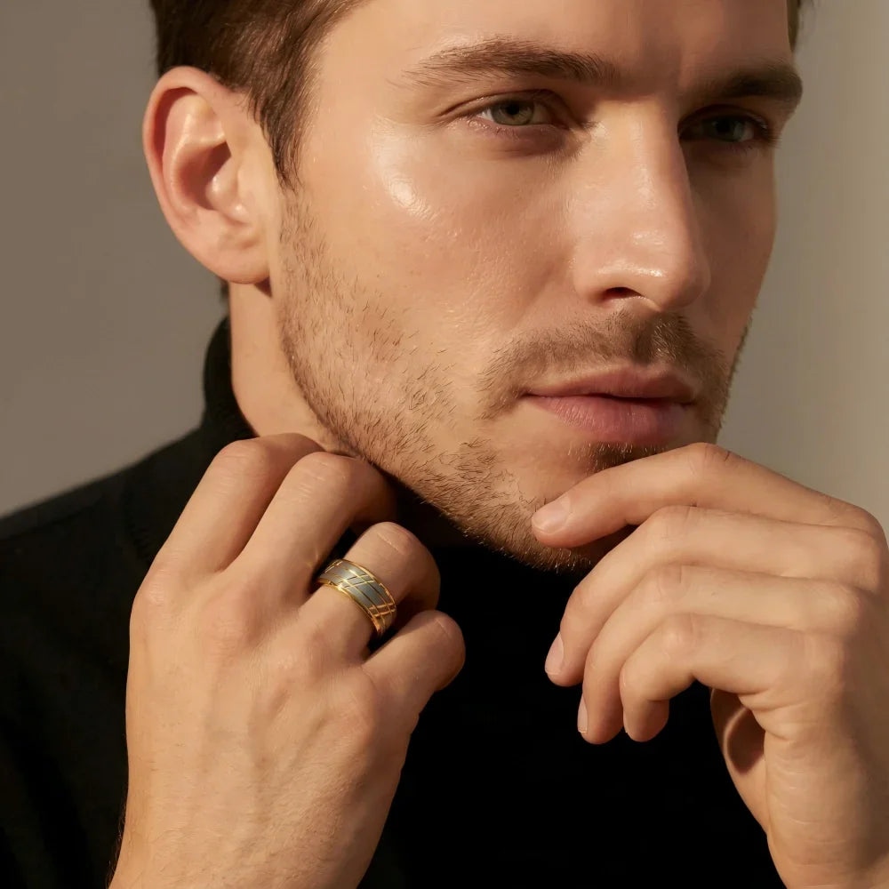 Man's hand wearing The Zenith Aerospace-grade Tungsten ring resting thoughtfully near the jawline in a focused, minimalist studio setting.