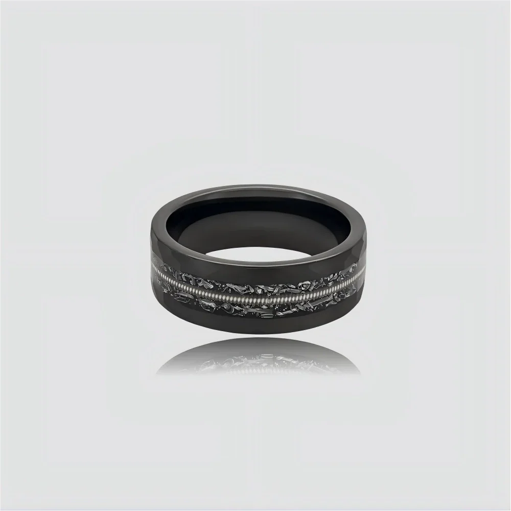 The Resonance Precision-engineered ring featuring faceted Obsidian and a signature guitar string inlay.