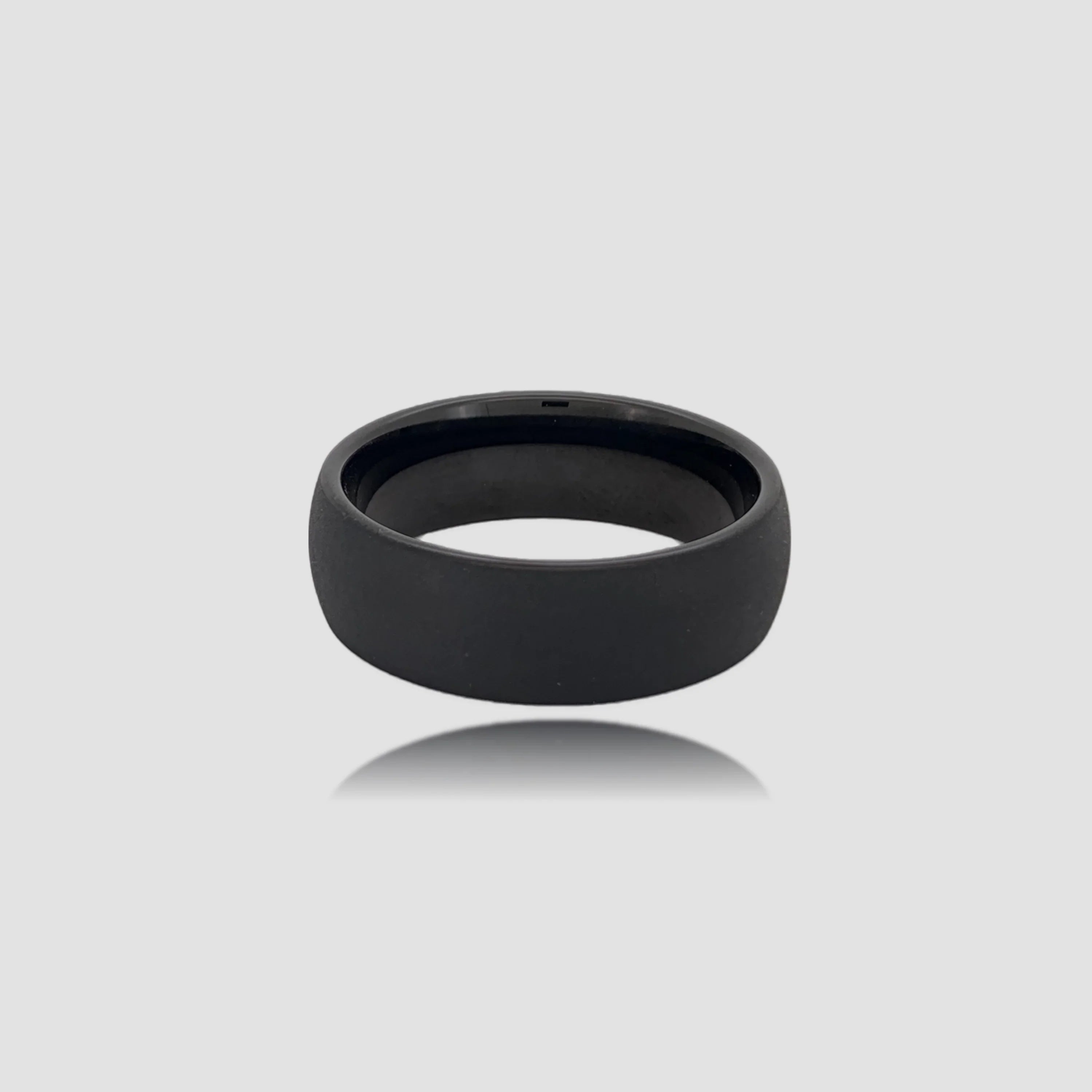 The Shadow Monolith Precision-engineered ring featuring a raw sandblasted finish on Black Aerospace-grade Tungsten.