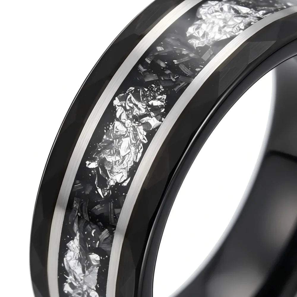Macro detail of faceted geometric edges and textured inlay on The Stellar Rift showcasing silver foil and Black Aerospace-grade Tungsten.