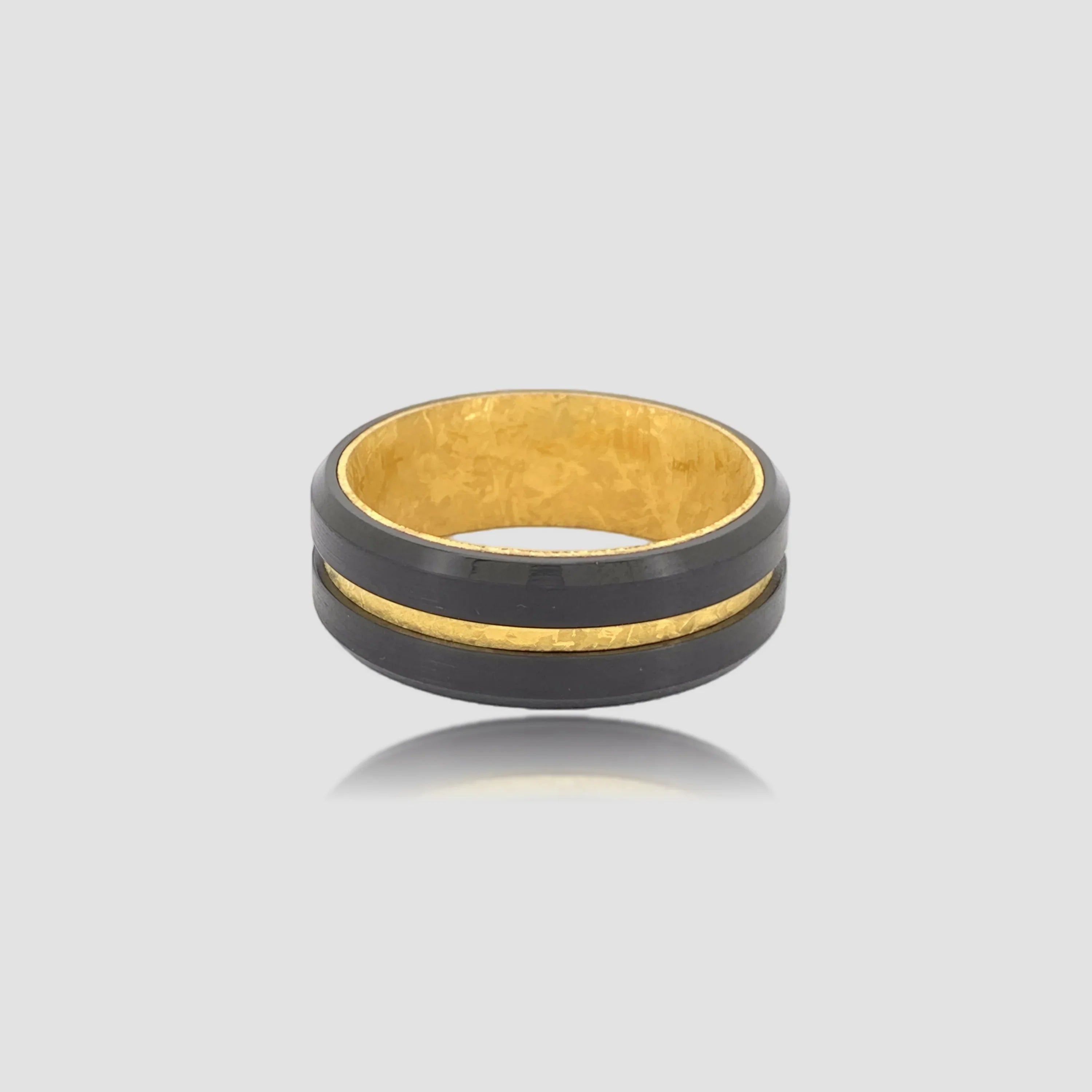 The Aurelius Spark Precision-engineered ring featuring Black Aerospace-grade Tungsten and precision-milled 18K Gold PVD coated gold foil.